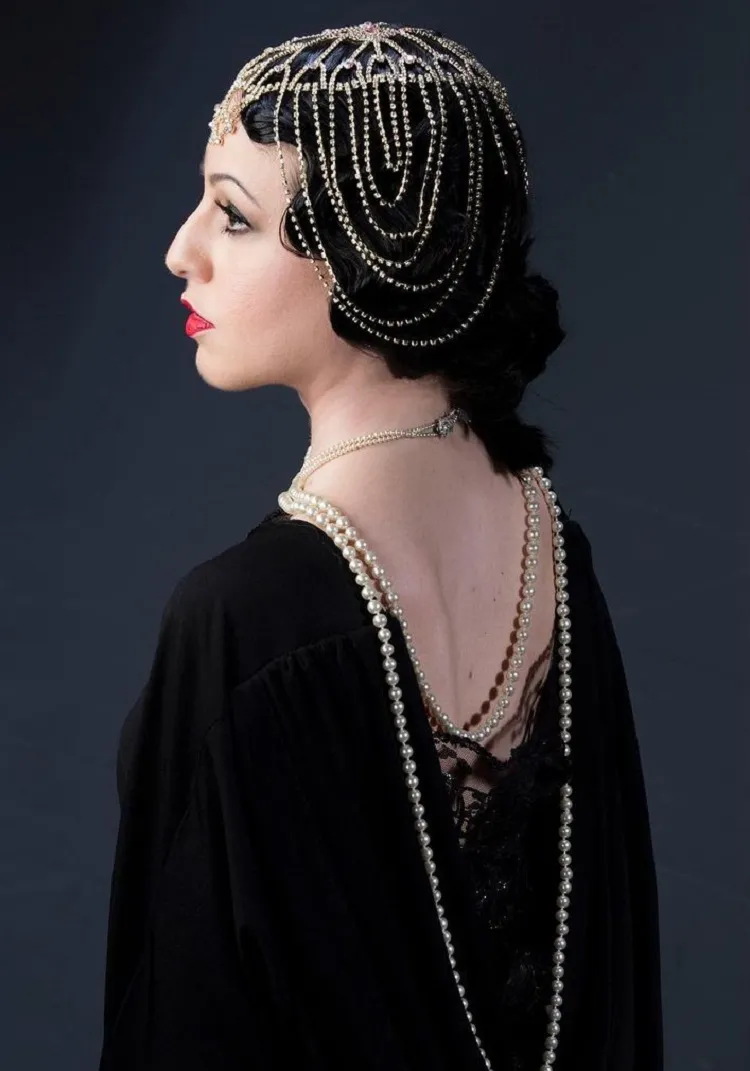 20s hairstyle for long hair with jewel hair accessory