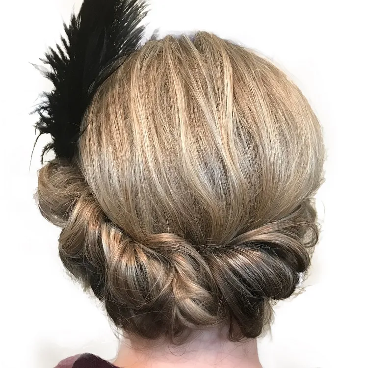 20s updo hairstyle with feather accessory