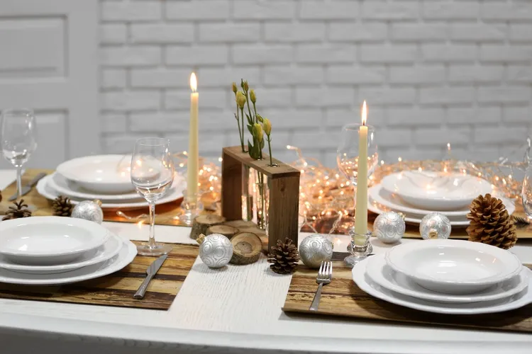 candles and fairy lights as a centerpies on a festive chriatmas table