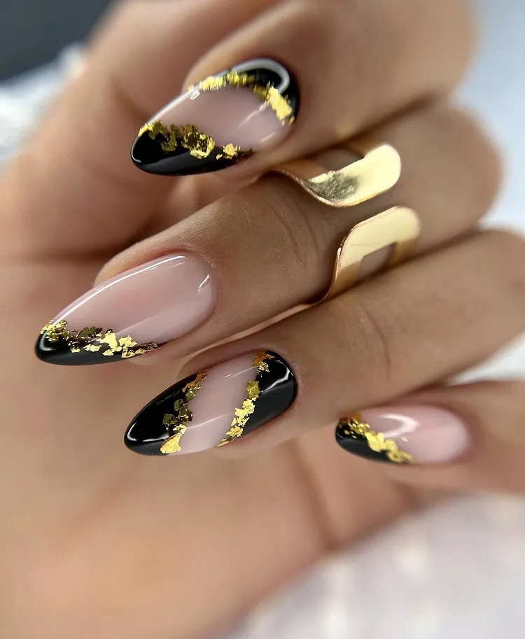 abstract black nails with gold leaf decorations festive christmas new years eve manicure