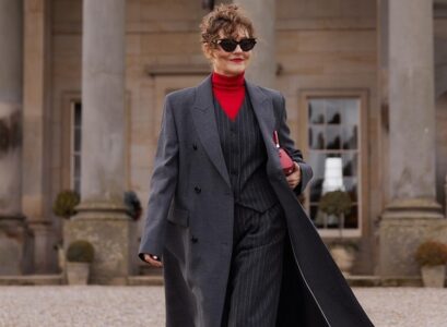 formal winter clothes woman over 70 gray coat two piece suit red turtleneck