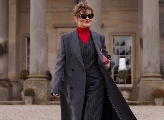 formal winter clothes woman over 70 gray coat two piece suit red turtleneck