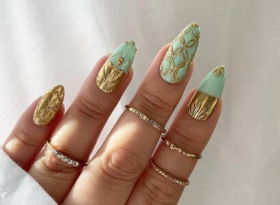 mint green nails gold ornaments festive manicure 2023
