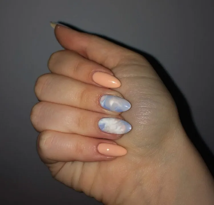 peach fuzz nails with blue nail art