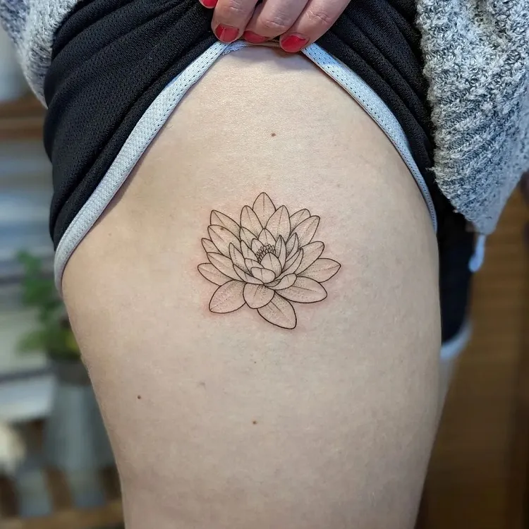 birth month flower tattoo idea on thigh july