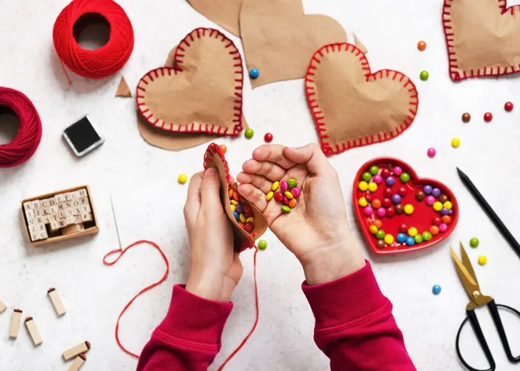 filling valentine's day paper heart with sweets