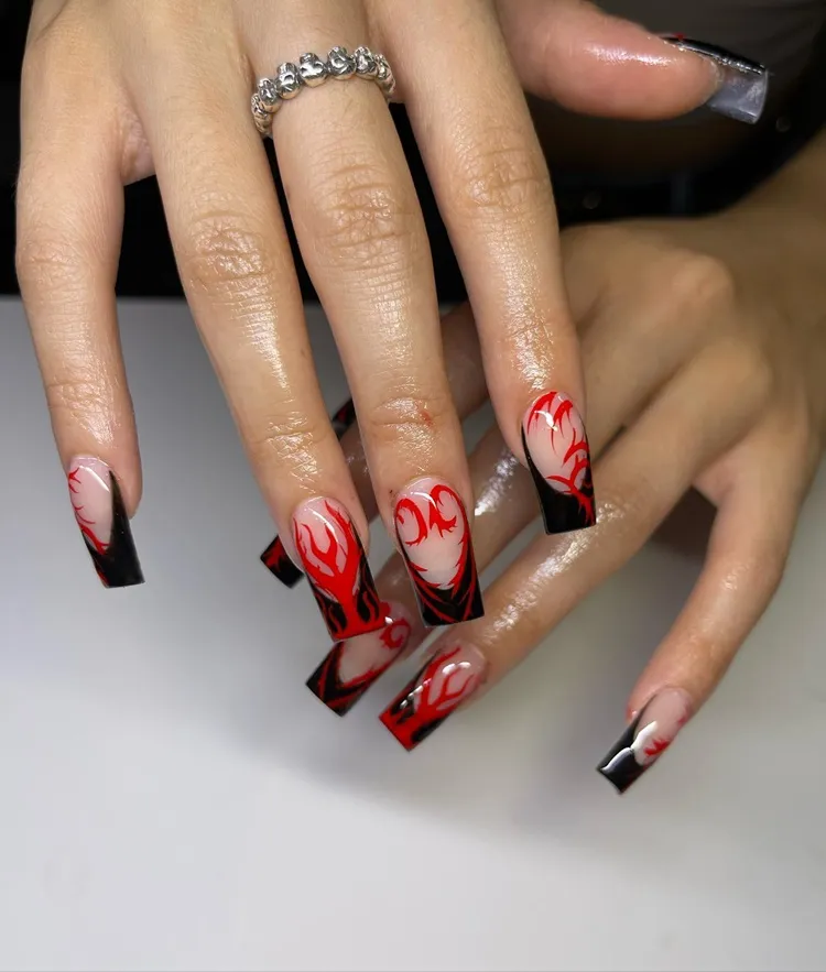 long square black tip french nails with edgy red hearts and flames