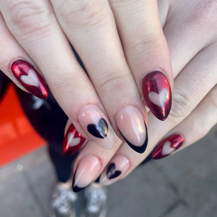 negative space red chrome hearts and black french tips valentine's manicure design