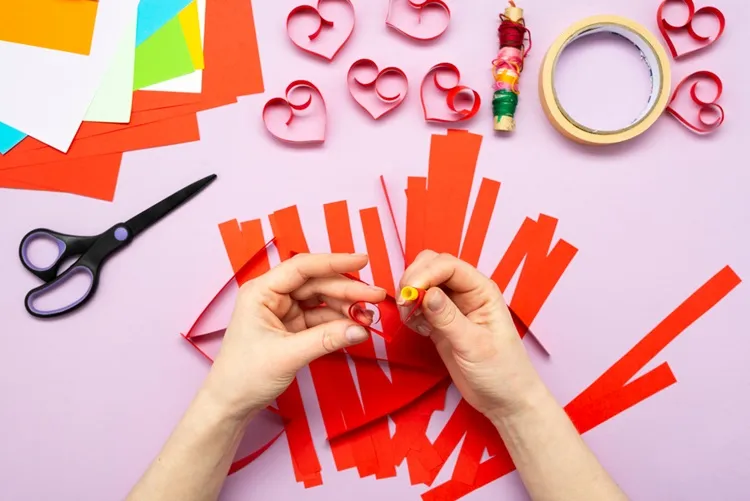 roll paper strips around a pen to make a heart