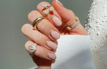short round bubble bath nails with a gold glitter window design 2024