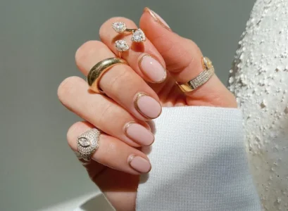 short round bubble bath nails with a gold glitter window design 2024