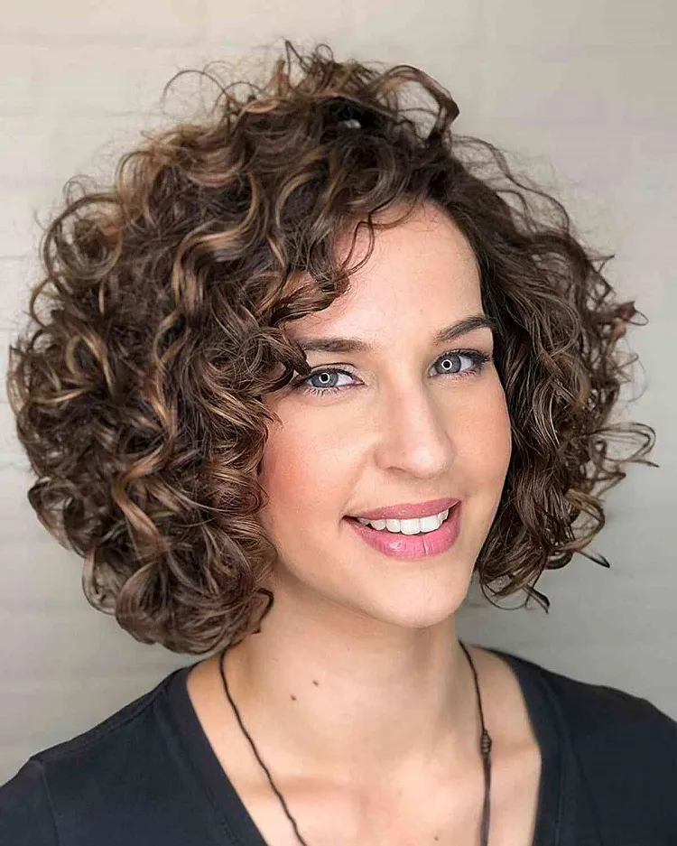 side parted thick short curly haircut