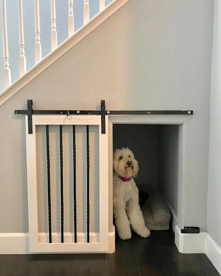 simple under stairs dog room idea with sliding door