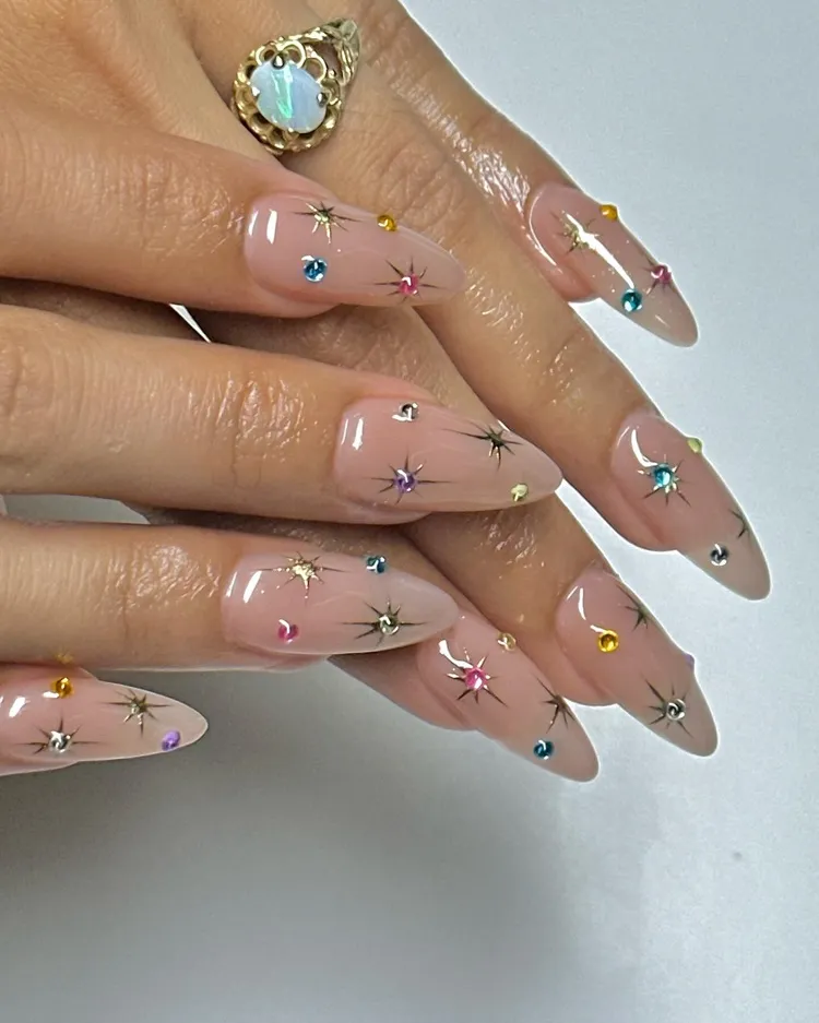 long almond shape clear nails with colorful gemstones