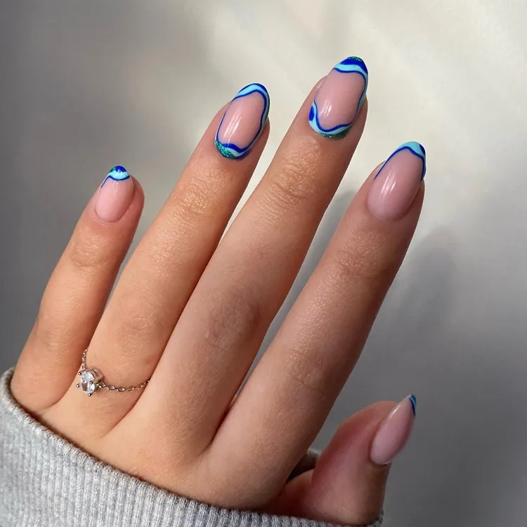 milky white oval nails with abstract blue twirly decorations