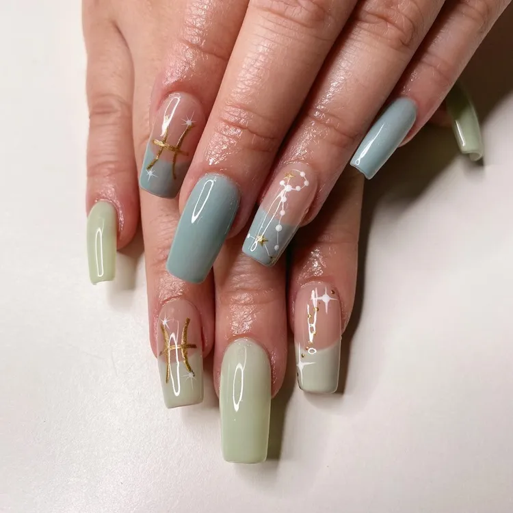 minimalist pastel blue green pisces birthday nails with celestial decorations