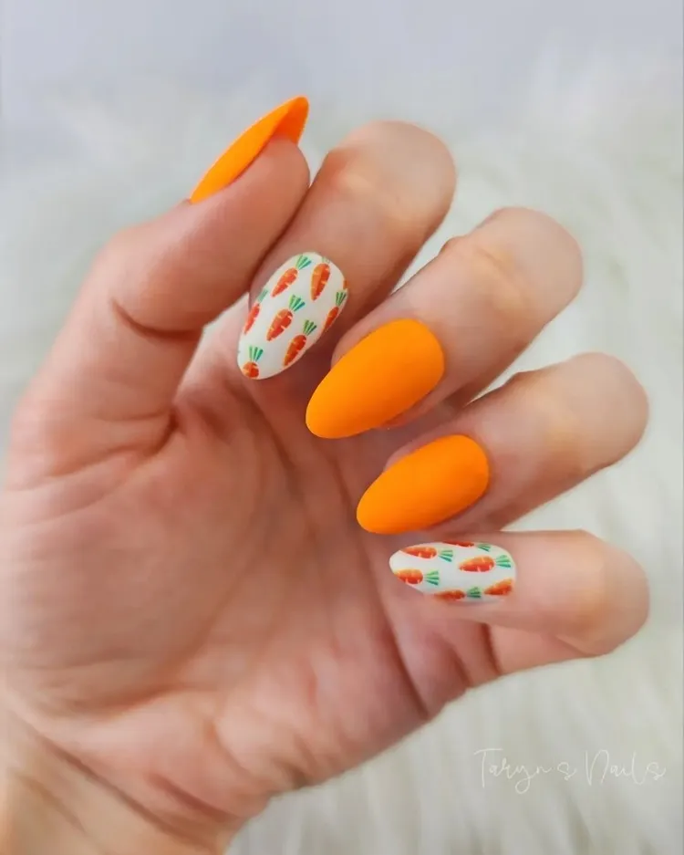 neon orange easter nails with mini carrots decoration