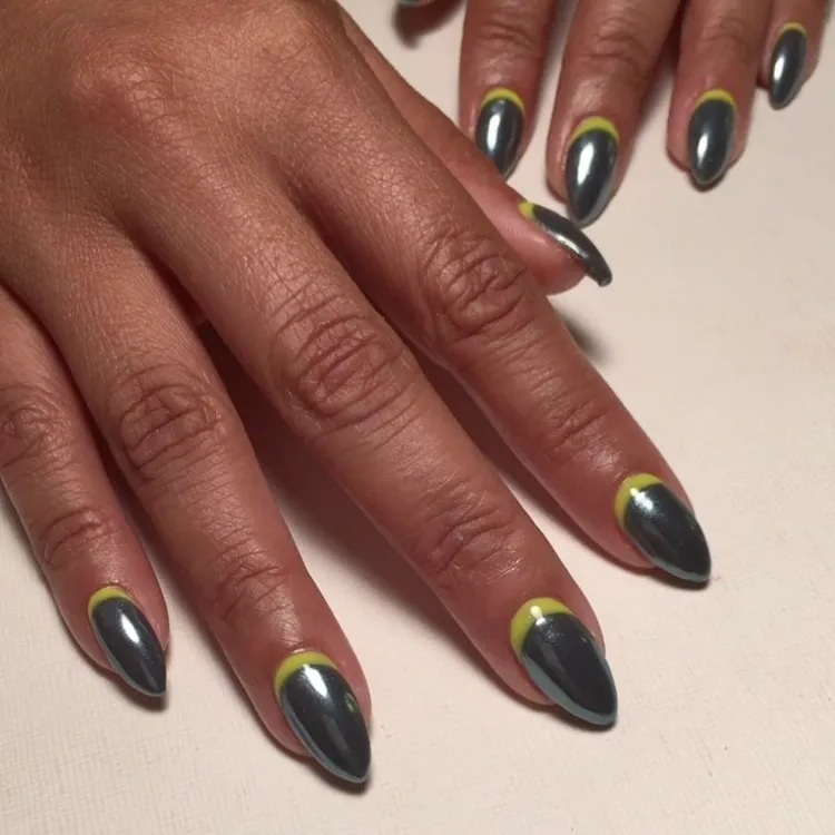 silver chrome nails with neon yellow reverse french tips