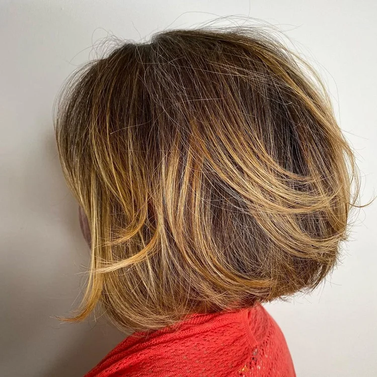 trendy feathered bob with honey balayage for mature women